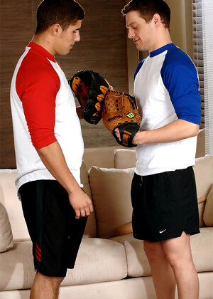 Baseball coach Andrew Blue kneels down and blows off pitcher Jimmy Clay