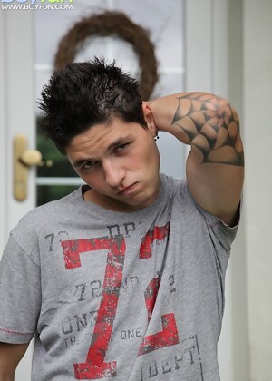 Tattooed stud Jeremy stroking his cock outdoors.