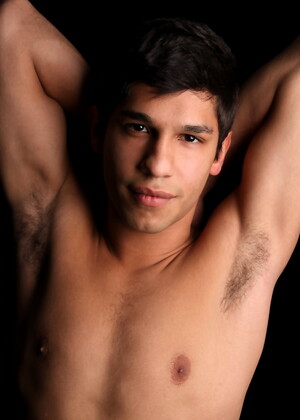 Carmine posing naked in a bedroom